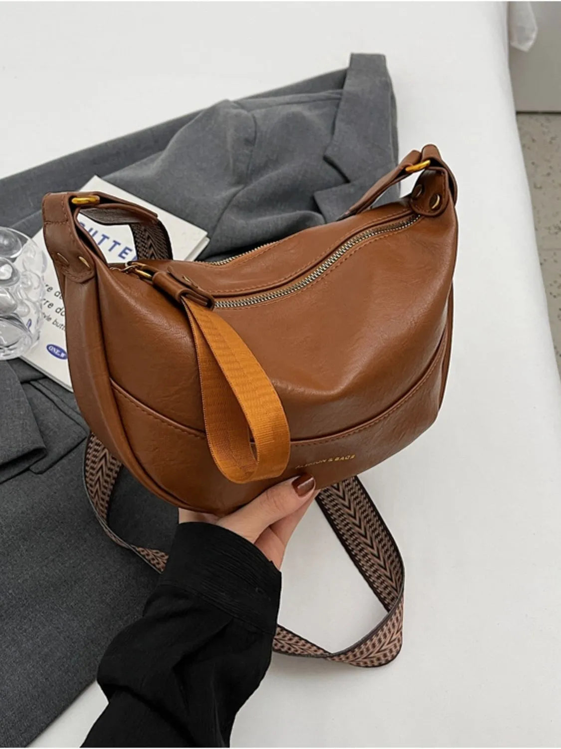 Stylish Leather Shoulder Bag with Woven Strap.