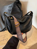 Stylish Leather Shoulder Bag with Woven Strap.