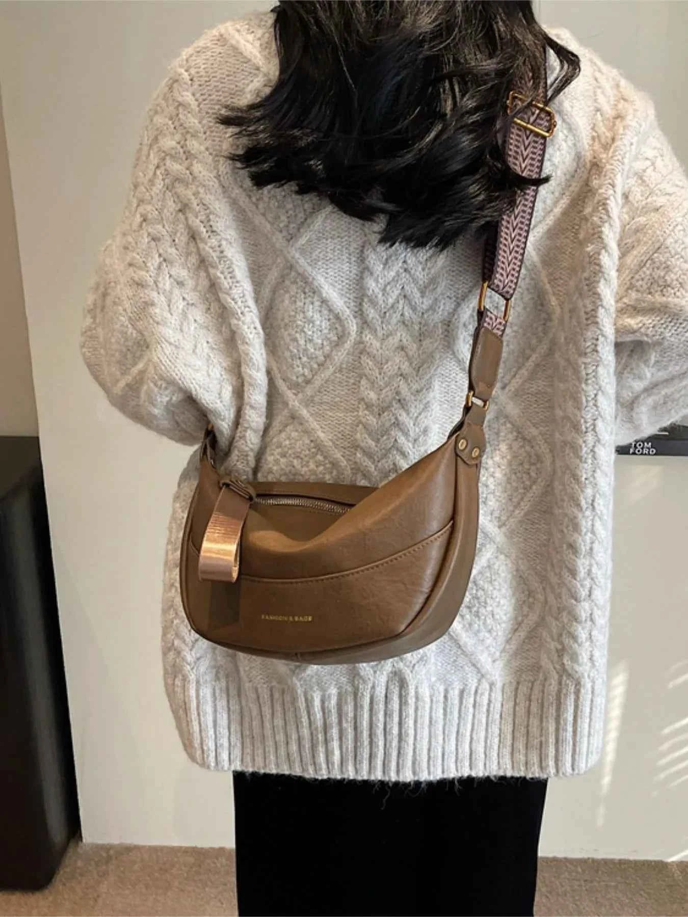 Stylish Leather Shoulder Bag with Woven Strap.