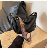 Stylish Leather Shoulder Bag with Woven Strap.