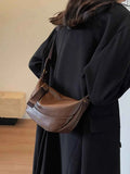 Stylish Leather Shoulder Bag with Woven Strap.