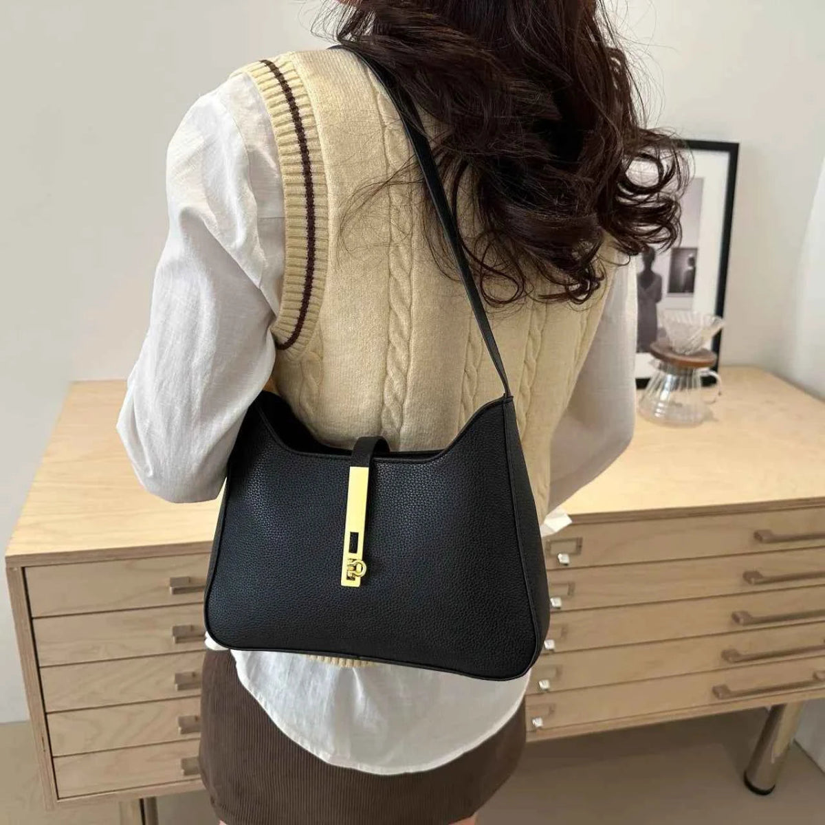 Small Leather Shoulder Bag with Gold Accent.