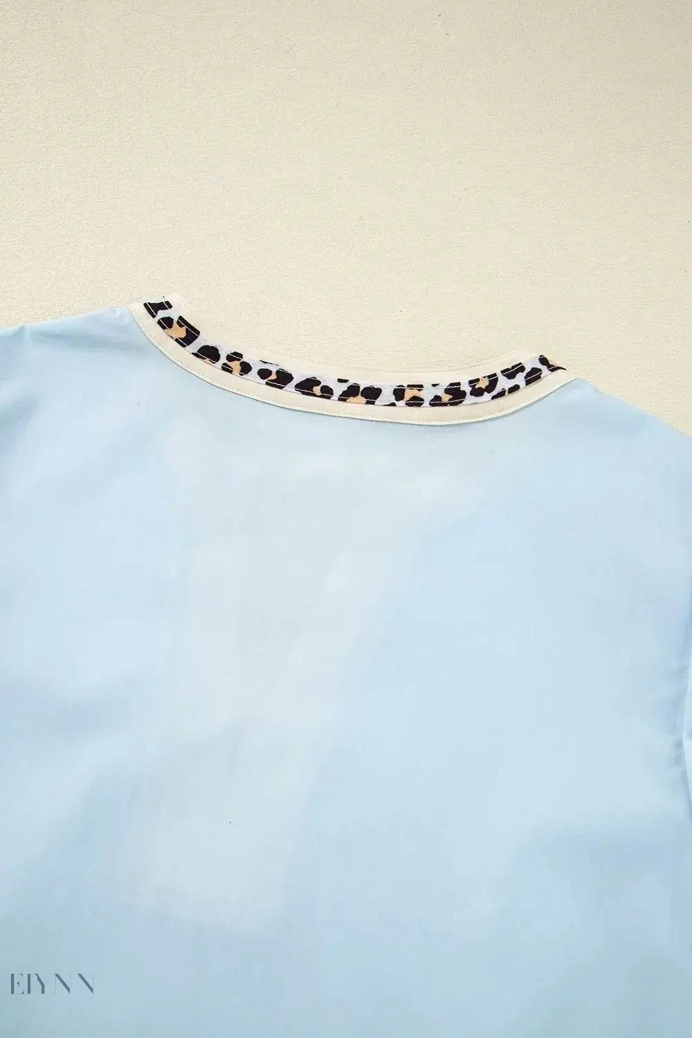 Trendy light blue puff sleeve blouse with leopard trim neckline and contrast detail leopard trim puff sleeve blouse