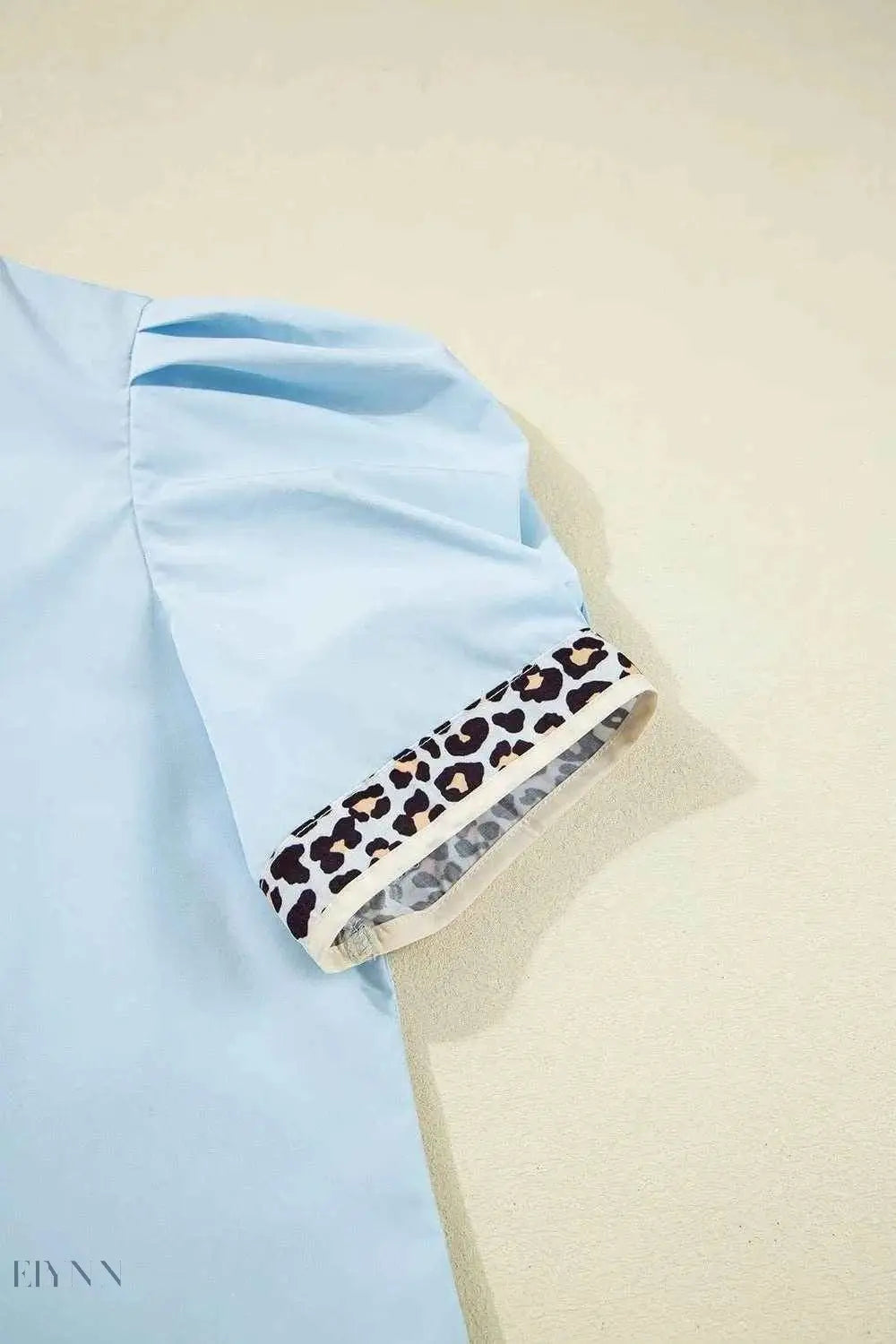 Light blue leopard trim puff sleeve blouse with gathered short sleeve and leopard cuff detail
