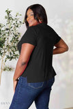 Plus size model wearing women's basic black t-shirt with short sleeves and side slits paired with jeans