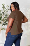 Plus size model wearing women's basic black t-shirt styled in brown back view with short sleeves side slits and jeans
