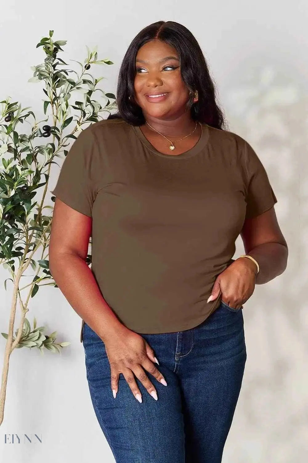 Trendsi plus size model wearing women's basic black t-shirt shown in brown with jeans casual styling