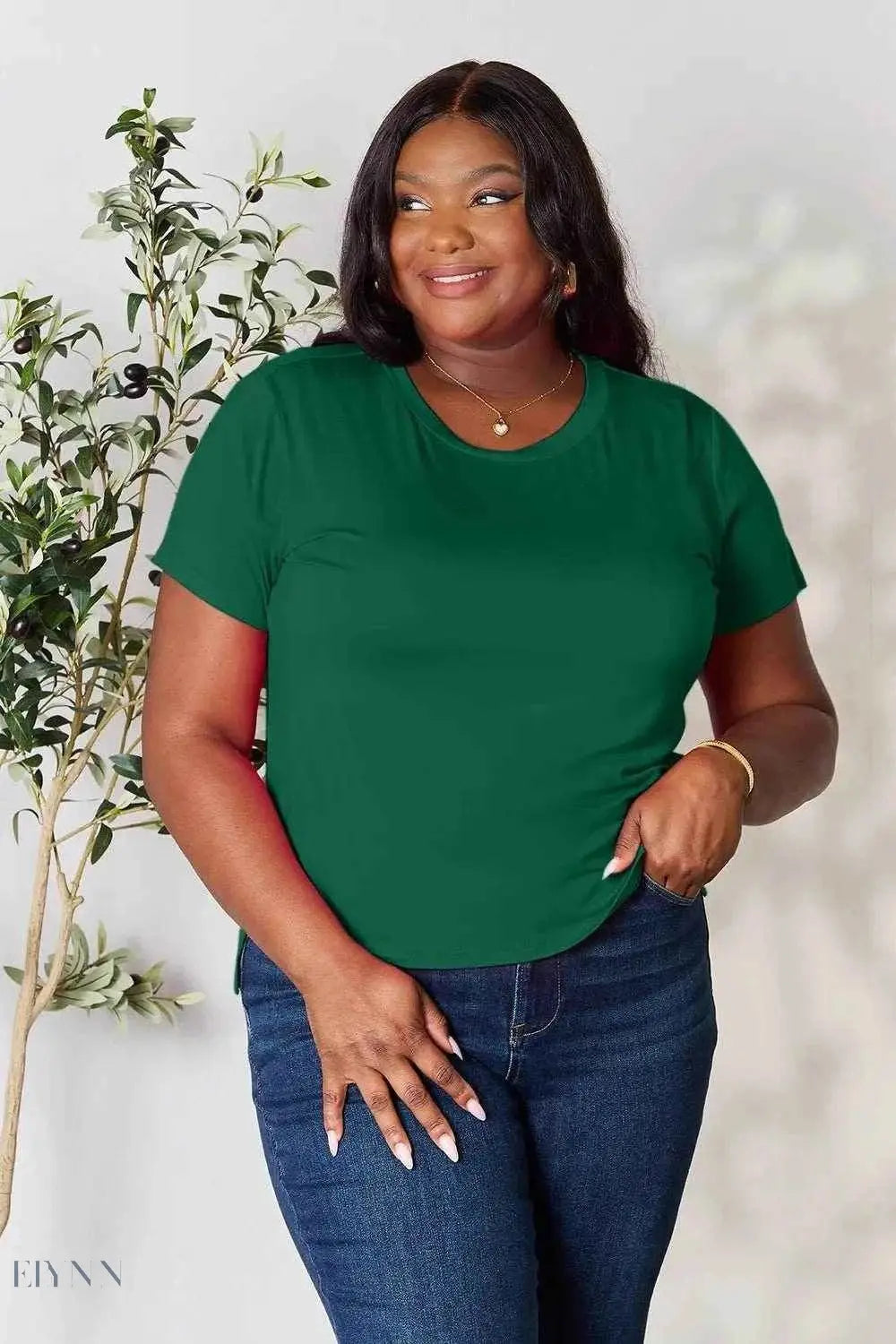 Trendsi plus size model wearing green short sleeve crewneck tee and jeans styled as women's basic black t-shirt