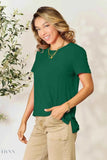 Trendsi women's basic black t-shirt shown on model in green color paired with khaki pants and gold necklace