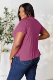 Plus size model back view wearing women's basic black t-shirt styled in maroon short sleeve with side slits and jeans