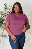 Plus size model wearing a plum crew neck tee and jeans, product variant labeled women's basic black t-shirt on Trendsi