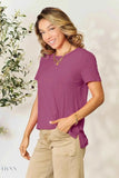 Trendsi women's basic black t-shirt listing shown on smiling model wearing plum short sleeve tee and beige pants