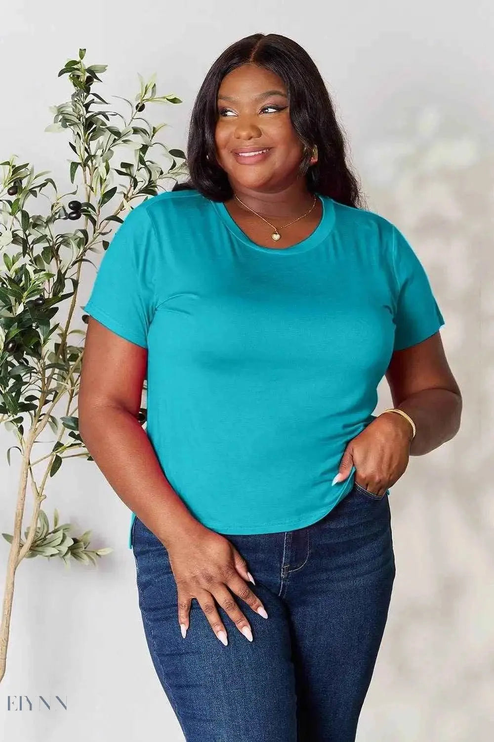Plus size model wearing teal crew neck tee from Trendsi women's basic black t-shirt collection