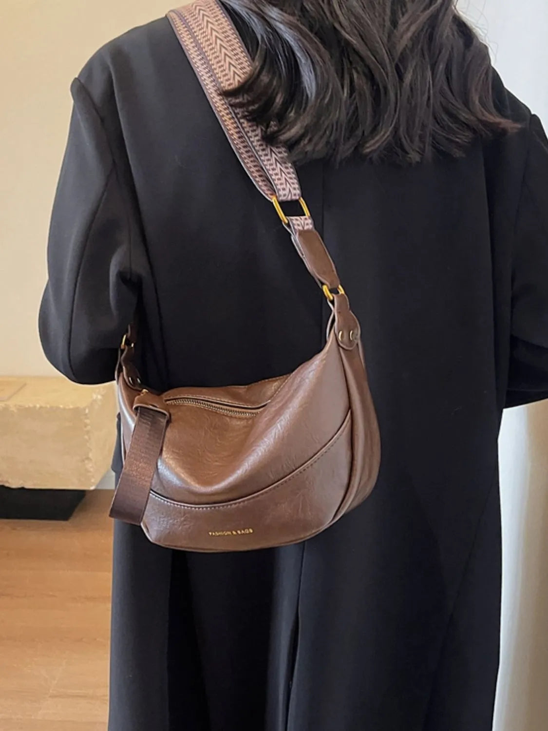 Stylish Leather Shoulder Bag with Woven Strap.