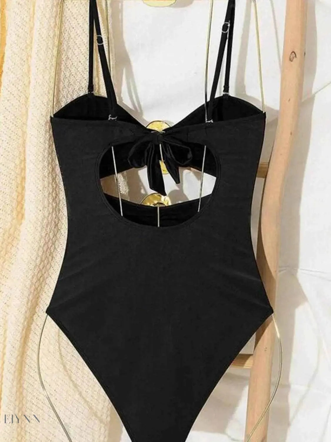 Cutout sweetheart one-piece swimsuit in black with bow detail and adjustable straps