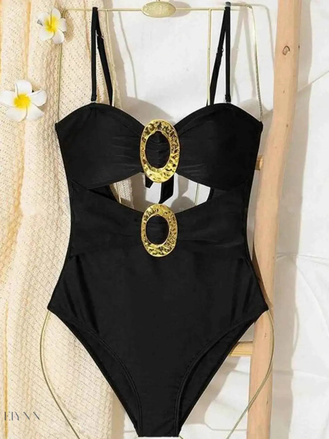Stylish cutout sweetheart one-piece swimsuit in black with bold gold accents