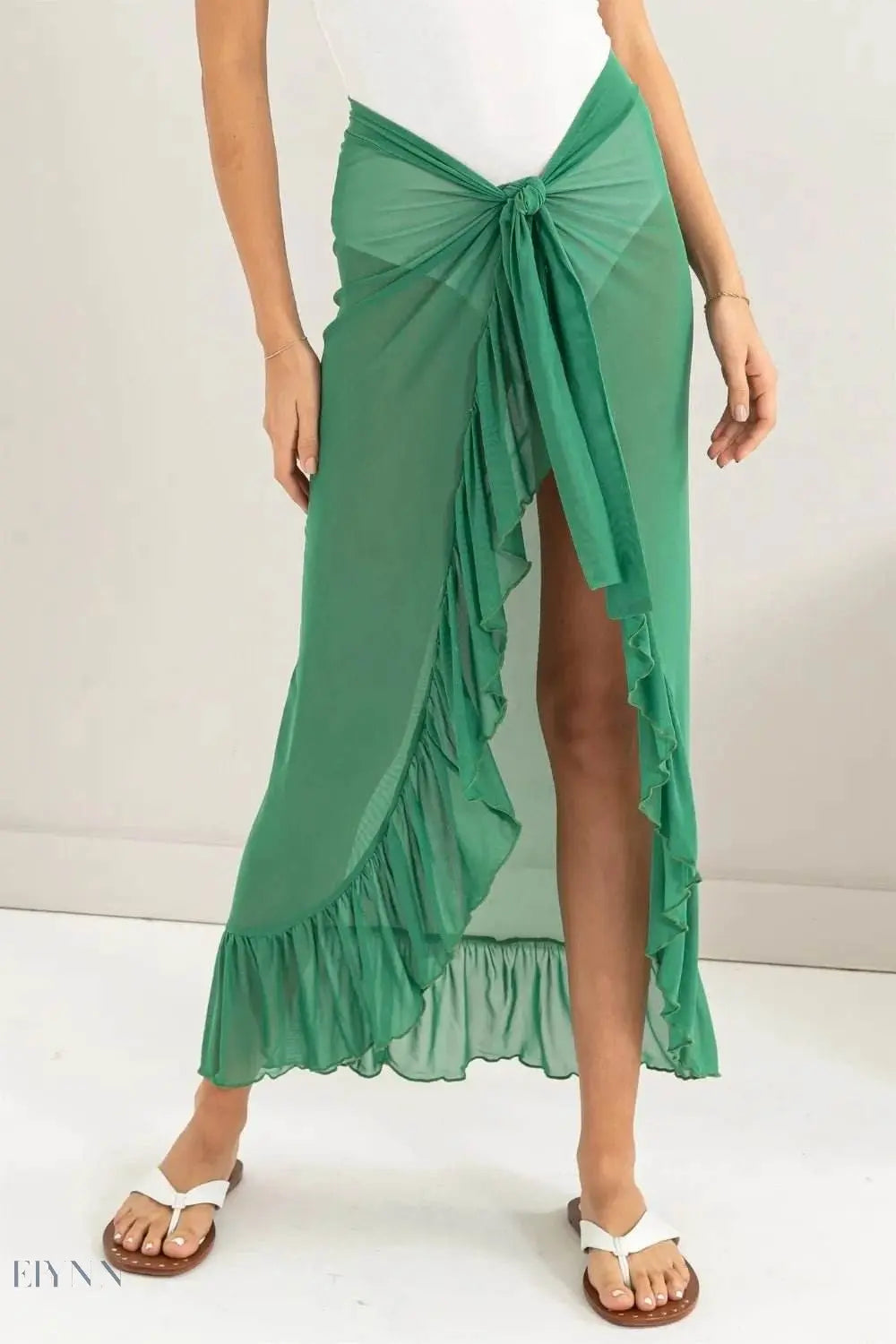 Elegant green ruffle trim sarong skirt with a stylish tie and flared design for chic beachwear